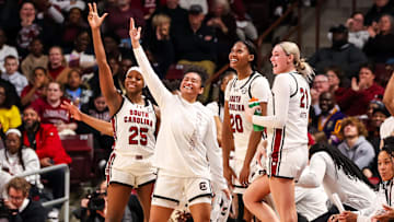 Feb 20, 2025; Columbia, South Carolina, USA; South Carolina Gamecocks guard Raven Johnson (25), guard Te-Hina Paopao (0), forward Sania Feagin (20) and forward Chloe Kitts (21) celebrate a play against the Arkansas Razorbacks in the second half at Colonial Life Arena. Mandatory Credit: Jeff Blake-Imagn Images