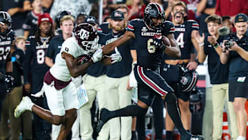 Nov 2, 2024; Columbia, South Carolina, USA; South Carolina Gamecocks tight end Joshua Simon (6) runs after a reception past Texas A&M Aggies defensive back Trey Jones III (9) in the second half at Williams-Brice Stadium. Mandatory Credit: Jeff Blake-Imagn Images
