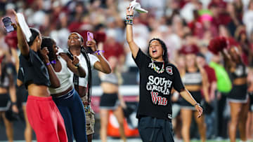 Sep 6, 2025; Columbia, South Carolina, USA; South Carolina Gamecocks head women’s basketball coach Dawn Staley leads the crowd in a cheer before the game against the South Carolina State Bulldogs at Williams-Brice Stadium. Mandatory Credit: Jeff Blake-Imagn Images