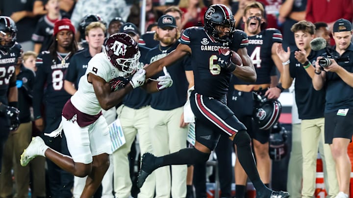 Nov 2, 2024; Columbia, South Carolina, USA; South Carolina Gamecocks tight end Joshua Simon (6) runs after a reception past Texas A&M Aggies defensive back Trey Jones III (9) in the second half at Williams-Brice Stadium. Mandatory Credit: Jeff Blake-Imagn Images