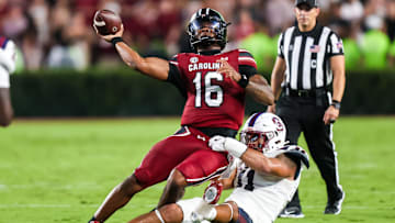Sep 6, 2025; Columbia, South Carolina, USA; South Carolina Gamecocks quarterback LaNorris Sellers (16) passes as he is brought down by South Carolina State Bulldogs defensive end Mike Lunz (11) in the second quarter at Williams-Brice Stadium. Mandatory Credit: Jeff Blake-Imagn Images