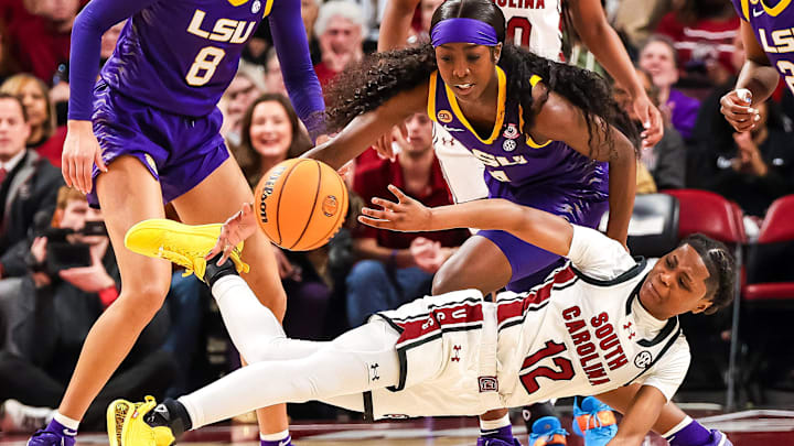Jan 24, 2025; Columbia, South Carolina, USA; South Carolina Gamecocks guard MiLaysia Fulwiley (12) passes away from LSU Lady Tigers guard Flau'Jae Johnson (4) in the first half at Colonial Life Arena. Mandatory Credit: Jeff Blake-Imagn Images