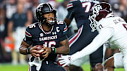 Nov 2, 2024; Columbia, South Carolina, USA; South Carolina Gamecocks quarterback LaNorris Sellers (16) eludes a sack by Texas A&M Aggies linebacker Scooby Williams (0) in the first quarter at Williams-Brice Stadium. Mandatory Credit: Jeff Blake-Imagn Images