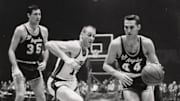 Jerry West drives on a defender during his NBA career.