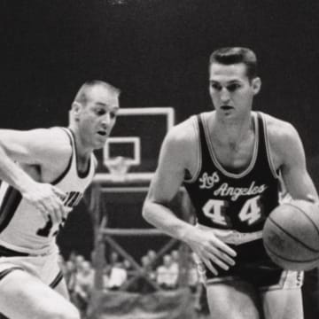 Jerry West drives on a defender during his NBA career.