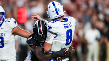Sep 27, 2025; Columbia, South Carolina, USA; South Carolina Gamecocks linebacker Desmond Umeozulu (9) hits Kentucky Wildcats quarterback Cutter Boley (8) as he passes which causes an interception in the second quarter at Williams-Brice Stadium. Mandatory Credit: Jeff Blake-Imagn Images