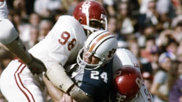Jan 1, 1972, New Orleans, LA, USA; FILE PHOTO; Oklahoma defensive lineman Lucious Selmon (98) tackles Auburn Tigers running back Tommy Lowry (24) during the 1972 Sugar Bowl. at Tulane Stadium. The Sooners defeated the Tigers 40-22. Mandatory Credit: Malcolm Emmons-Imagn Images