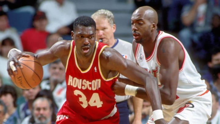 Houston Rockets center Hakeem Olajuwon in action against John Salley of the Miami Heat at the Miami Arena during the 1994-95 season. 