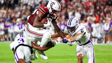 South Carolina football tight end Josh Simon hurdling a defender last season against the Furman Paladins