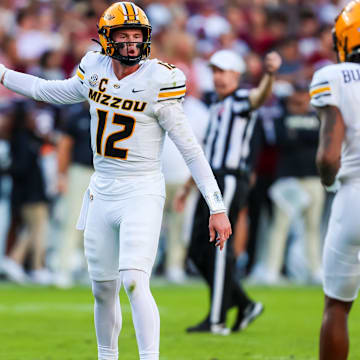 Nov 16, 2024; Columbia, South Carolina, USA; Missouri Tigers quarterback Brady Cook (12) directs his offense against the South Carolina Gamecocks in the first quarter at Williams-Brice Stadium. Mandatory Credit: Jeff Blake-Imagn Images