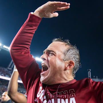 Nov 16, 2024; Columbia, South Carolina, USA; South Carolina Gamecocks head coach Shane Beamer celebrates beating the Missouri Tigers at Williams-Brice Stadium. He is holding the Mayors Cup, given to the winner of the South Carolina-Missouri game. Mandatory Credit: Jeff Blake-Imagn Images
