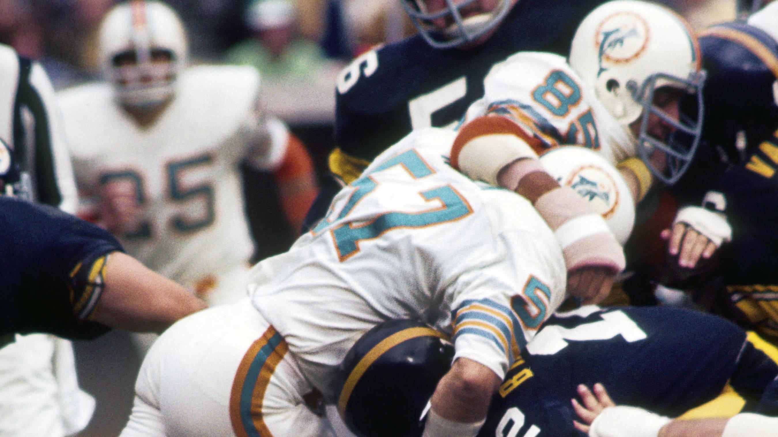 Mike Kolen (57) teams with Nick Buoniconti to bring down Terry Bradshaw in the 1972 AFC Championship Game.