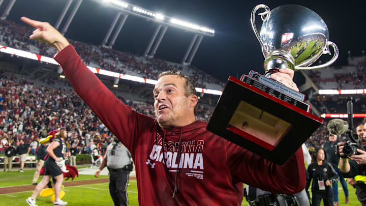 Nov 16, 2024; Columbia, South Carolina, USA; South Carolina Gamecocks head coach Shane Beamer celebrates beating the Missouri Tigers at Williams-Brice Stadium. He is holding the Mayors Cup, given to the winner of the South Carolina-Missouri game. Mandatory Credit: Jeff Blake-Imagn Images