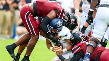 South Carolina football freshman Dylan Stewart sacking the quarterback with an assist from Kyle Kennard and Monkell Goodwine