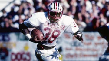 Nov 1, 1980; Athens, GA, USA; FILE PHOTO; South Carolina Gamecocks running back George Rogers (38) carries the ball against the Georgia Bulldogs at Sanford Stadium. Mandatory Credit: Malcolm Emmons-Imagn Images