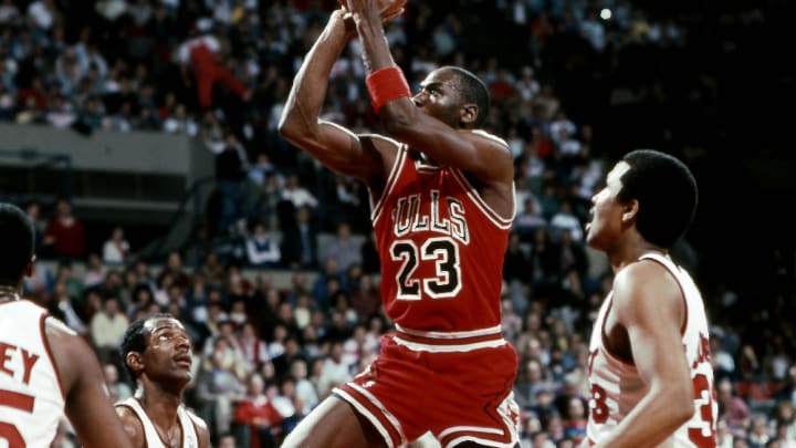 Mar 22, 1987; Portland, OR, USA: FILE PHOTO; Chicago Bulls guard Michael Jordan (23) shoots the ball between Portland Trail Blazers guard Clyde Drexler (22) and Steve Johnson (33) at Memorial Coliseum. Mandatory Credit: USA TODAY Sports