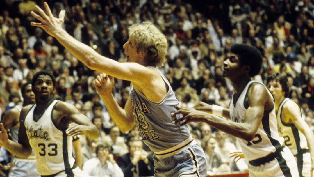 Mar 26, 1979; Salt Lake City, UT, USA; FILE PHOTO; Indiana State Sycamores forward Larry Bird (33) reaches for the ball under pressure from Michigan State Spartans guard Magic Johnson (33) 