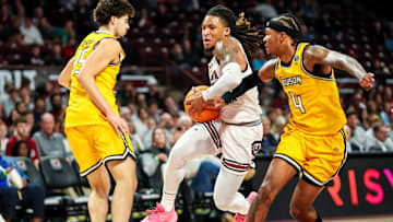 Nov 12, 2024; Columbia, South Carolina, USA; South Carolina Gamecocks guard Jamarii Thomas (6) drives past Towson Tigers guard Dylan Williamson (4) and guard Tyler Tejada (15) at Colonial Life Arena. Mandatory Credit: Jeff Blake-Imagn Images