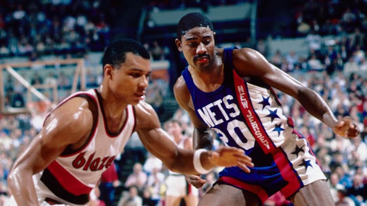 Nov 19, 1985; Portland, OR, USA: FILE PHOTO; New Jersey Nets guard Michael Ray Richardson (20) battles for a loose ball against Portland Trailblazers guard Darnell Valentine (left) at Memorial Coliseum. Mandatory Credit: Imagn Images Nov 19, 1985; Portland, OR, USA: FILE PHOTO; New Jersey Nets guard Michael Ray Richardson (20) battles for a loose ball against Portland Trailblazers guard Darnell Valentine (left) at Memorial Coliseum. Mandatory Credit: Imagn Images