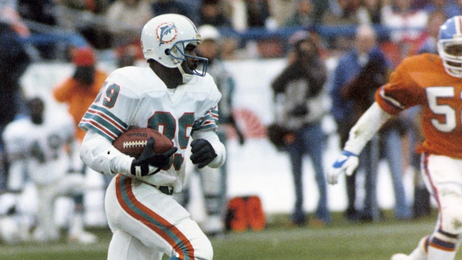 Miami Dolphins receiver Nat Moore (89) carries the ball against the Denver Broncos at Mile High Stadium in a 1985 game. | Rod Hanna-USA TODAY Sports