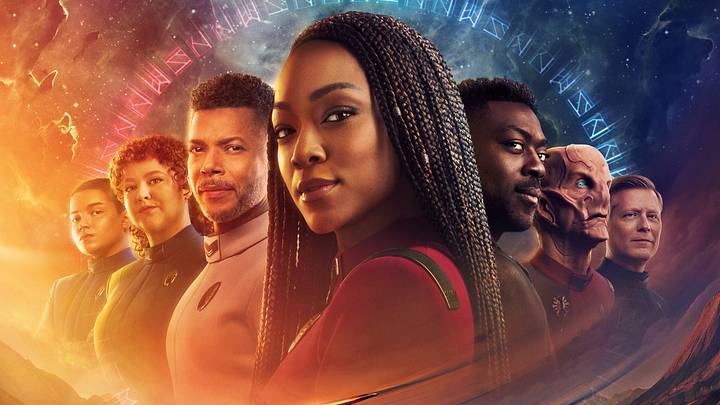 L-R Blu Del Barrio as Adira, Mary Wiseman as Tilly, Wilson Cruz as Culber, Sonequa Martin-Green as Burnham, David Ajala as Book, Doug Jones as Saru and Anthony Rapp as Stamets in season 5 of the Paramount+ original series STAR TREK: DISCOVERY. Photo Credit: James Dimmock/Paramount+