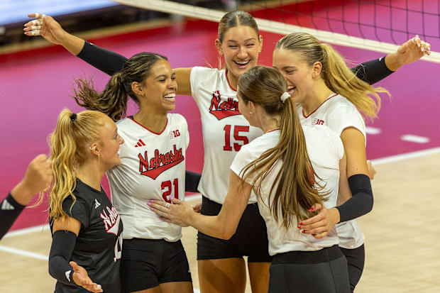 Members of the white team celebrate a point during the Red-White Scrimmage on Saturday.
