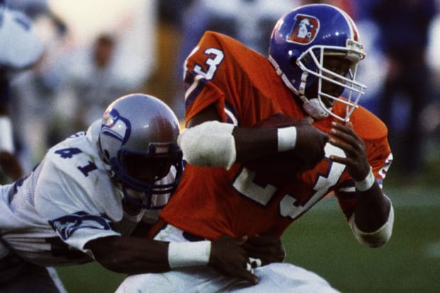 Denver Broncos running back Sammy Winder (23) in action against Seattle Seahawks safety Eugene Robinson (41) .