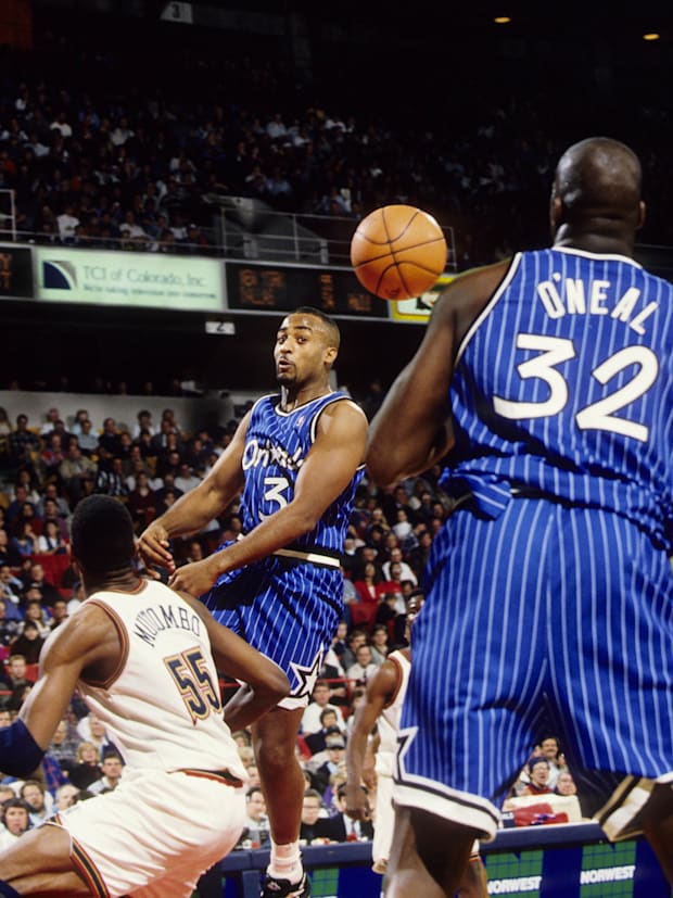 Orlando Magic guard Dennis Scott (3) passes the ball to Shaquile O'Neal (32) against the Denver Nuggets