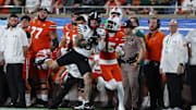 Iowa State Cyclones wide receiver Jaylin Noel runs with Miami Hurricanes star Markeith Williams during the Pop Tarts bowl