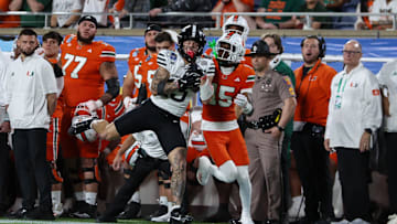 Iowa State Cyclones wide receiver Jaylin Noel runs with Miami Hurricanes star Markeith Williams during the Pop Tarts bowl