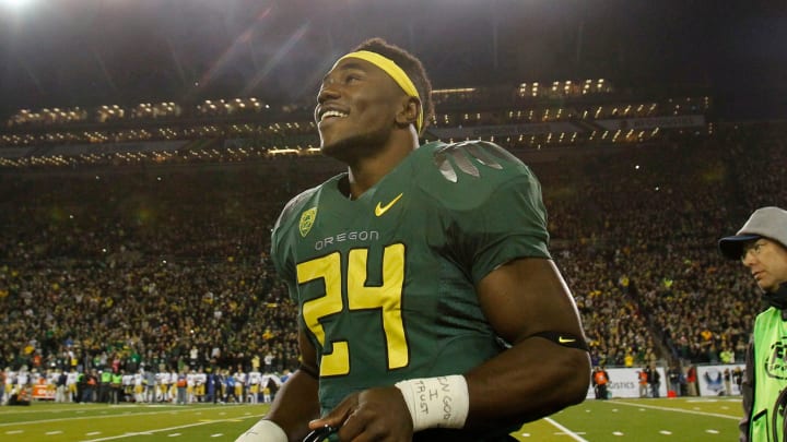 Kenjon Barner looks up at the fans as fireworks mark the end of the playing of the National Anthem before the Pac-12 Championship game.

Eug 113021 Pac12 Champs 02