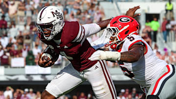 Mississippi State Bulldogs quarterback Kamario Taylor (1) runs with the ball against Georgia Bulldogs linebacker Raylen Wilson (5) during the second half at Davis Wade Stadium at Scott Field.