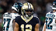 Sep 22, 2024; New Orleans, Louisiana, USA; New Orleans Saints wide receiver Chris Olave (12) reacts to making a first down reception against Philadelphia Eagles safety Reed Blankenship (32) during the first half at Caesars Superdome. Mandatory Credit: Stephen Lew-Imagn Images