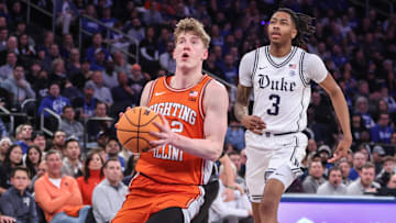 Feb 22, 2025; New York, NY, USA;  Illinois Fighting Illini guard Kasparas Jakucionis (32) drives past Duke Blue Devils guard Isaiah Evans (3) in the second half at Madison Square Garden. Mandatory Credit: Wendell Cruz-Imagn Images