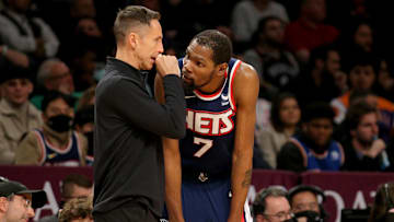 Brooklyn Nets head coach Steve Nash talks to forward Kevin Durant during the fourth quarter against the Phoenix Suns.