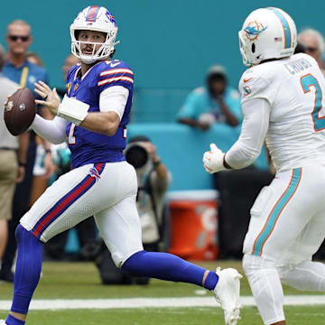 Buffalo Bills quarterback Josh Allen scrambles against Miami Dolphins linebacker Bradley Chubb.