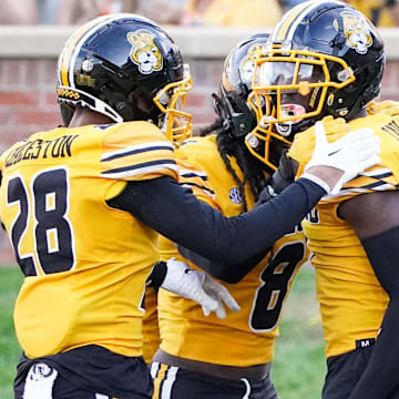 Oct 22, 2022; Columbia, Missouri, USA; Missouri Tigers defensive back Jaylon Carlies (1) celebrates with defensive back Joseph Charleston (28) and linebacker Ty'Ron Hopper (8) after making an interception in the end zone against the Vanderbilt Commodores during the first half of the game at Faurot Field at Memorial Stadium. Mandatory Credit: Denny Medley-Imagn Images