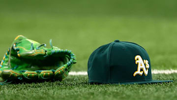 Athletics glove and hat on the field before the game against the Texas Rangers at Globe Life Field in Arlington, Texas, on July 22, 2025.