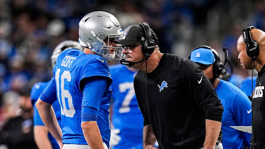 Detroit Lions quarterback Jared Goff talks to head coach Dan Campbell