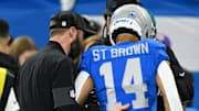 Nov 27, 2025; Detroit, Michigan, USA; Detroit Lions wide receiver Amon-Ra St. Brown (14) is helped off the field against the Green Bay Packers during the first quarter at Ford Field. Mandatory Credit: Lon Horwedel-Imagn Images