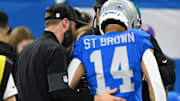 Nov 27, 2025; Detroit, Michigan, USA; Detroit Lions wide receiver Amon-Ra St. Brown (14) is helped off the field against the Green Bay Packers during the first quarter at Ford Field. 