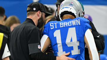 Nov 27, 2025; Detroit, Michigan, USA; Detroit Lions wide receiver Amon-Ra St. Brown (14) is helped off the field against the Green Bay Packers during the first quarter at Ford Field. 
