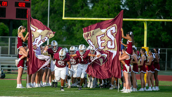 Oak Hall blasts onto the field before a spring football game at Oak Hall School in Gainesville, FL on Thursday, May 23, 2024. [Alan Youngblood/Gainesville Sun]