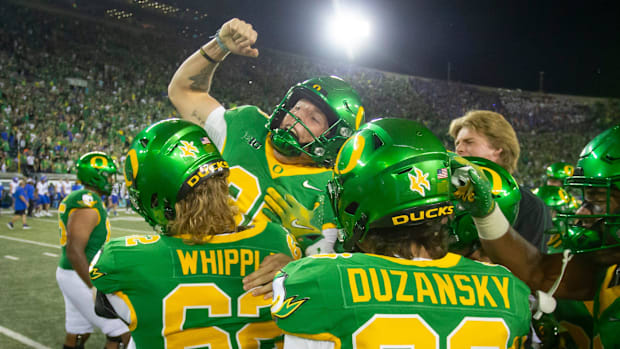 Oregon kicker Atticus Sappington is hoisted into the air after kicking the game winning field goal