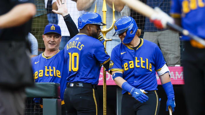 Seattle Mariners center fielder Victor Robles (10) taps designated hitter Justin Turner (2) on the back after hitting a solo-home run against the Philadelphia Phillies during the first inning at T-Mobile Park on Aug. 2.