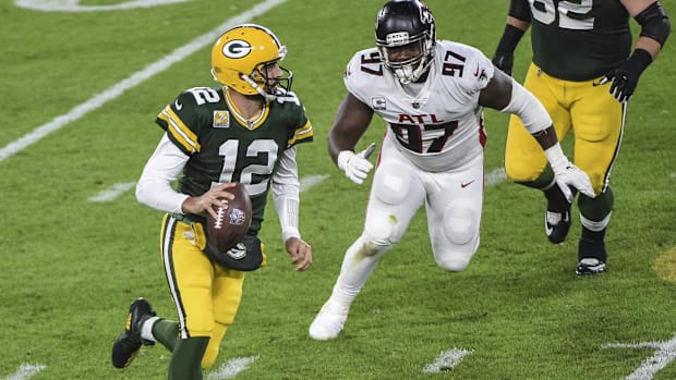 Aaron Rodgers scrambles to escape Grady Jarrett at Lambeau Field. 