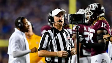 Sep 4, 2021;  College Station, Texas, USA;  NCAA referee Marc Curles review a play on the field during the time out of the game between the Texas A&M Aggies and the Kent State Golden Flashes at Kyle Field. Mandatory Credit: Maria Lysaker-Imagn Images