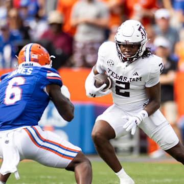 Sep 14, 2024; Gainesville, Florida, USA; Texas A&M Aggies running back Rueben Owens (2) runs toward Florida Gators linebacker Shemar James (6) during the first half at Ben Hill Griffin Stadium. Mandatory Credit: Matt Pendleton-Imagn Images