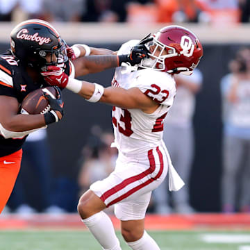 Oklahoma State's Rashod Owens (10) stiff arms Oklahoma's Jasiah Wagoner (23) during a Bedlam college football game between the Oklahoma State University Cowboys (OSU) and the University of Oklahoma Sooners (OU) at Boone Pickens Stadium in Stillwater, Okla., Saturday, Nov. 4, 2023.