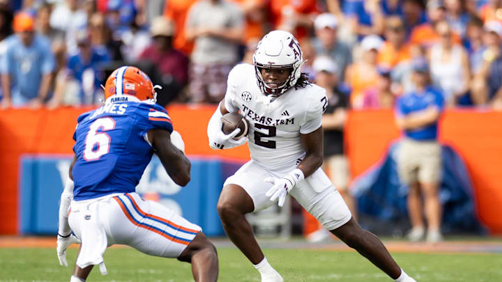 Sep 14, 2024; Gainesville, Florida, USA; Texas A&M Aggies running back Rueben Owens (2) runs toward Florida Gators linebacker Shemar James (6) during the first half at Ben Hill Griffin Stadium. Mandatory Credit: Matt Pendleton-Imagn Images